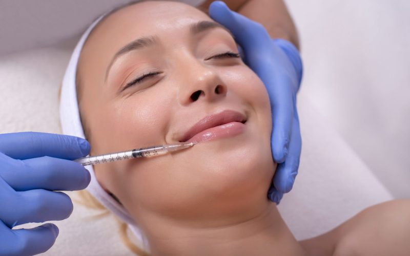 A beautiful young Caucasian female during skin treatment with hyaluronic acid in a beauty clinic