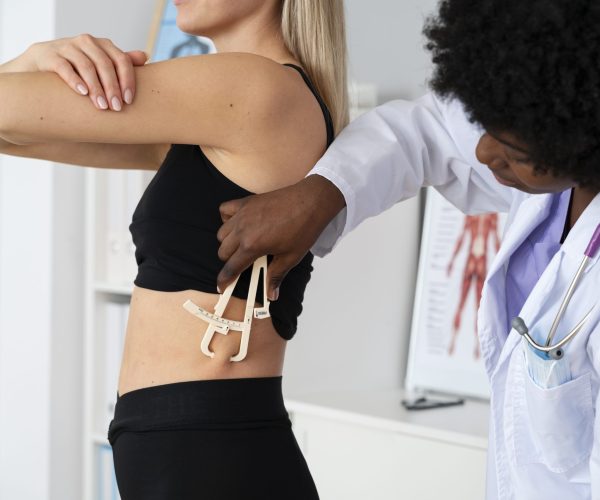 side-view-doctor-using-adipometer